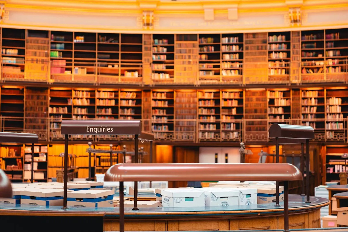 A grand domed library reading room lined with bookshelves