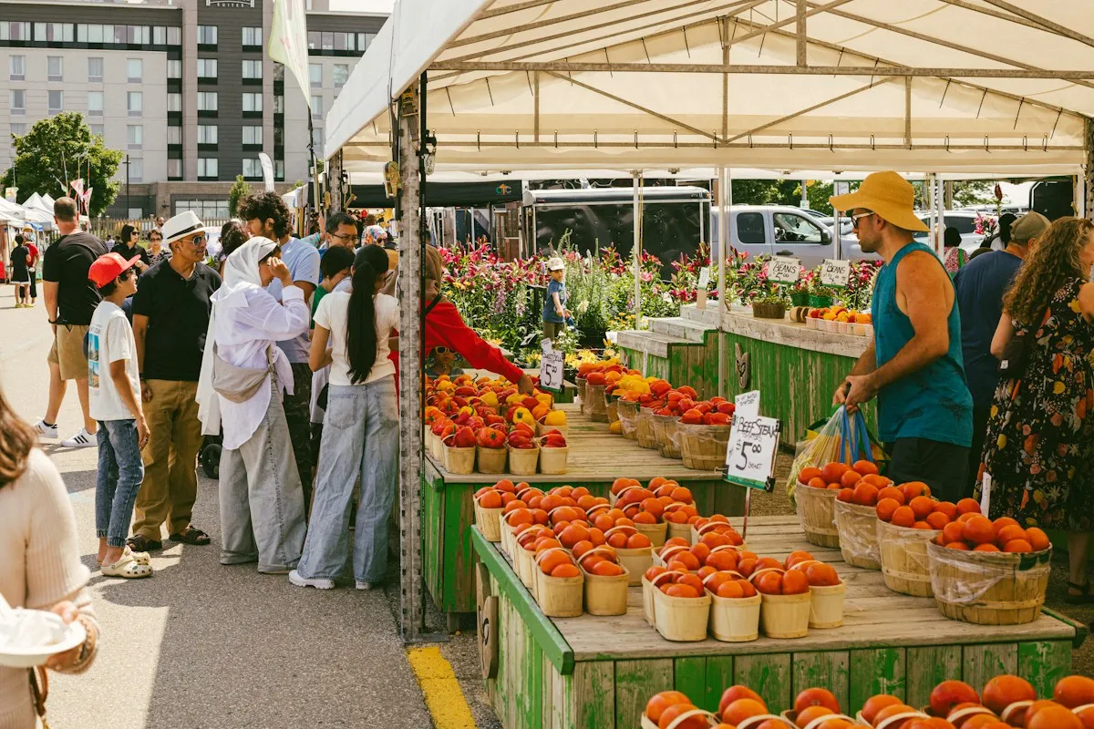 People shopping for fresh produce at an outdoor farmers market