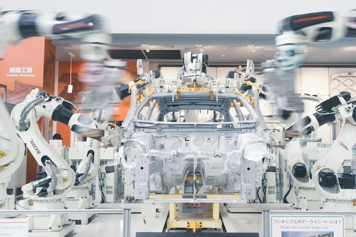 Robotic arms assembling a car body on a factory line