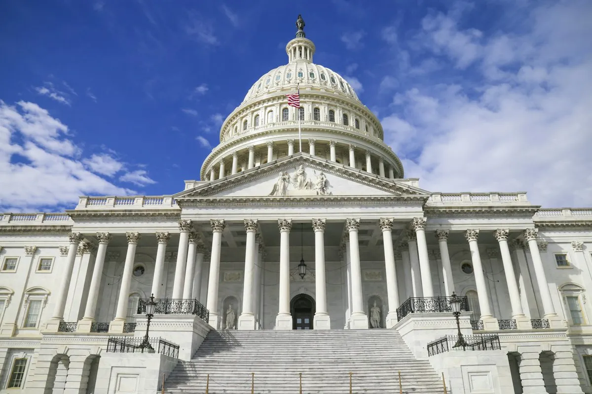 The United States Capitol dome against a blue sky